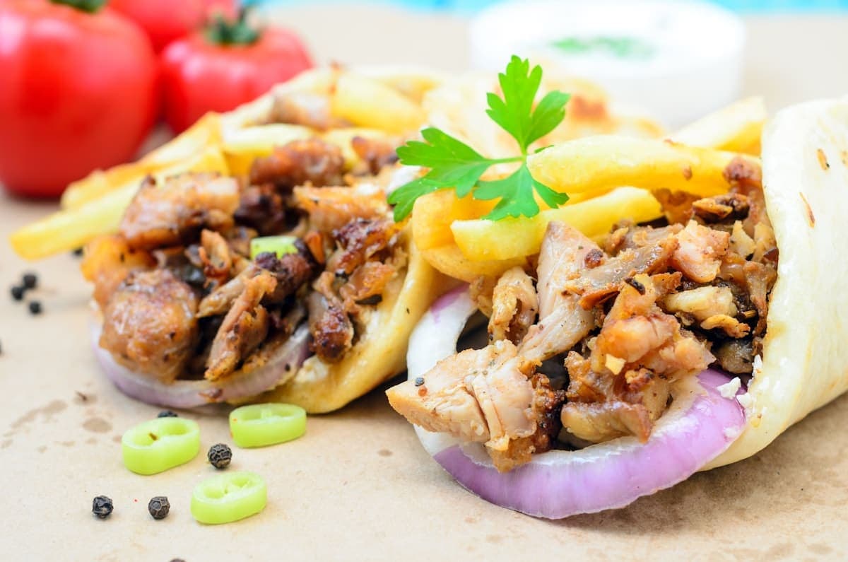 Two chicken shawarma wraps with fries