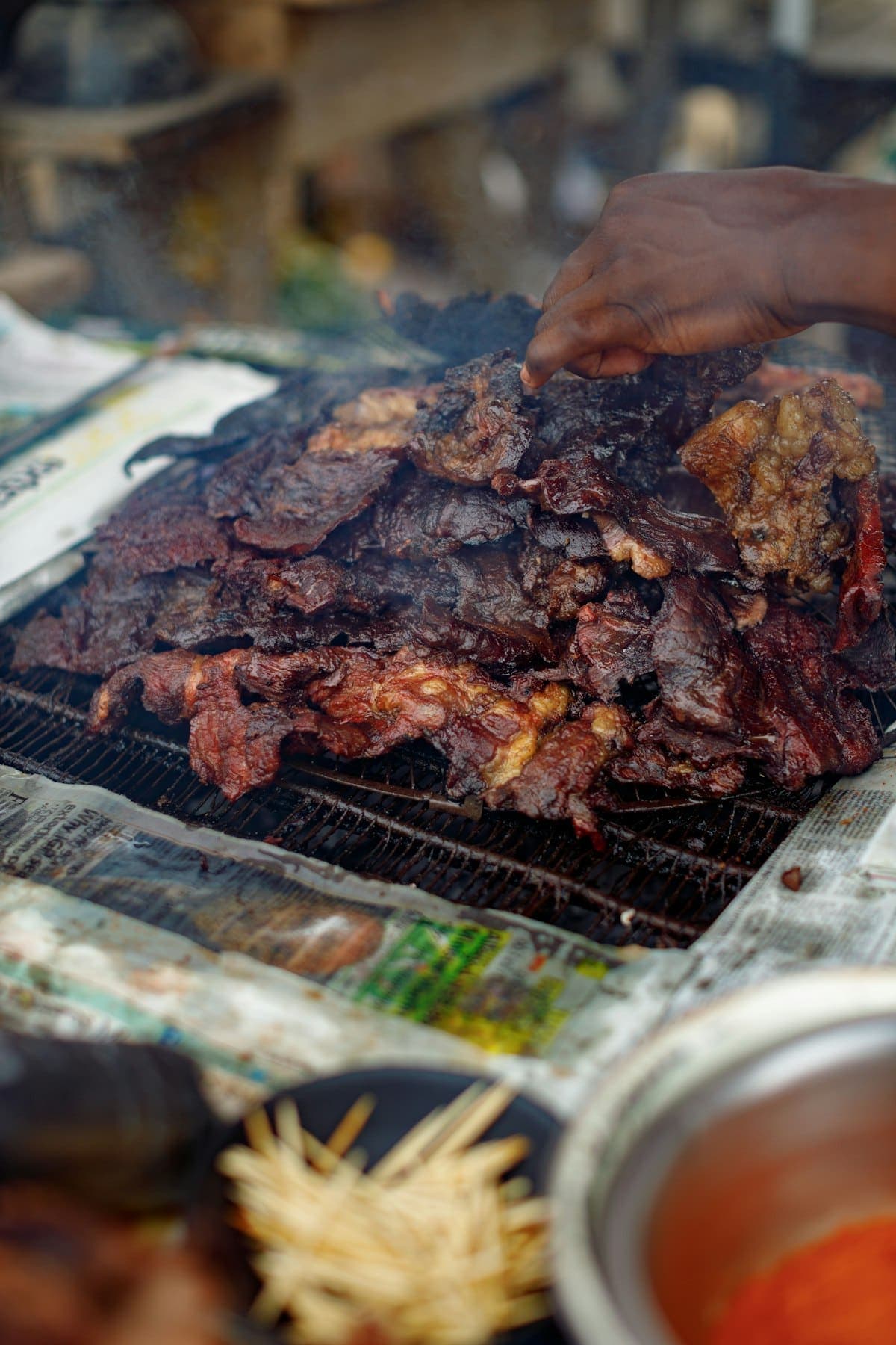 Suya being turned over an open flame